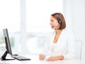 Friendly female helpline operator with computer Royalty Free Stock Photo