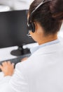 Friendly female helpline operator with headphones Royalty Free Stock Photo