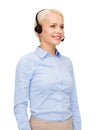 Friendly female helpline operator with headphones Royalty Free Stock Photo