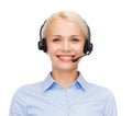 Friendly female helpline operator with headphones Royalty Free Stock Photo