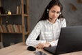 friendly female helpline operator with laptop, call center agent woman with headset using laptop and talking to a client Royalty Free Stock Photo