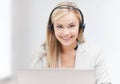 Friendly female helpline operator with laptop Royalty Free Stock Photo