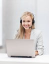 Friendly female helpline operator with laptop Royalty Free Stock Photo