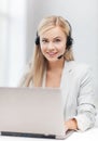 Friendly female helpline operator with laptop Royalty Free Stock Photo