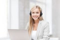 Friendly female helpline operator with laptop Royalty Free Stock Photo