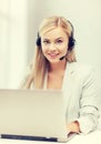 Friendly female helpline operator with laptop Royalty Free Stock Photo