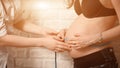 Friendly female medicine doctor holding centimeter tape and listening to pregnant woman standing for encouragement