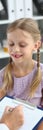 Friendly female pediatrician doctor holding clipboard listening to child girl Royalty Free Stock Photo