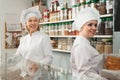 Friendly female staff offering sweets Royalty Free Stock Photo