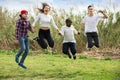 Friendly girls and boys posing in spring park Royalty Free Stock Photo