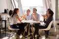 Friendly happy diverse workers laughing eating pizza together in Royalty Free Stock Photo