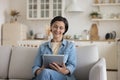 Friendly happy freelance woman using tablet for doing remote job Royalty Free Stock Photo