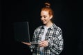 Friendly happy young business woman or student holding laptop computer and looking at display. Royalty Free Stock Photo