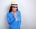 Friendly healthy woman in summer hat drinking still water on blu Royalty Free Stock Photo