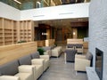 Friendly hospital interior waiting area with modern leather arm chairs and fire place