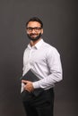 A friendly Indian businessman confidently holds a laptop