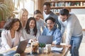 Friendly international business team looking at laptop screen, watching presentation Royalty Free Stock Photo