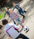 Friendly kids playing street football outdoors Royalty Free Stock Photo