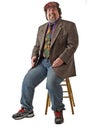 Friendly large man sits and laughs Royalty Free Stock Photo