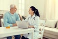 Friendly looking doctor talking to elderly man during consultation Royalty Free Stock Photo