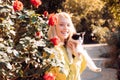 Friendly-looking joyful attractive european woman blonde haircolor smiling holding a cat happily carefree gazing camera Royalty Free Stock Photo