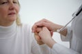 Friendly male doctor's hands holding female patient's hand for encouragement and empathy. Partnership, trust and Royalty Free Stock Photo