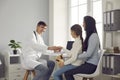 Pediatrician meets the little patient and shakes her hand before the medical examination. Royalty Free Stock Photo