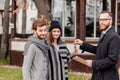 Friendly male real estate agent handing house key to a smiling young couple in office Royalty Free Stock Photo