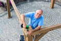 Friendly man erecting a new wooden gazebo