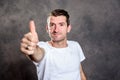 Friendly man with thumb up in front of gray background Royalty Free Stock Photo