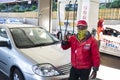 Friendly and masked petrol attendant