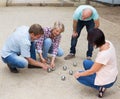 friendly mature couples playing petanque at leisure