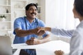 Friendly mature indian doctor man smiling and shaking female patient hand Royalty Free Stock Photo
