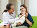 Friendly mature pediatrician doctor examining newborn Royalty Free Stock Photo