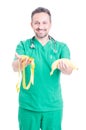 Friendly medic with banana and measuring tape