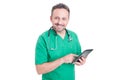 Friendly medical consultant holding tablet