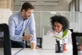 Friendly mentor explaining task African American employee