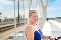 Friendly middle-aged blond woman smiling at the camera