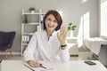 Friendly middle-aged female doctor waving hand greeting a patient via video link.