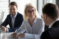 Friendly middle aged female leader laughing at group business meeting Royalty Free Stock Photo