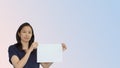 Friendly mixed race casual Asian mature woman presenting gesture with copy space for advertising