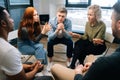 Young group of multiethnic business people share ideas during brainstorming on background of window. Royalty Free Stock Photo