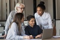 Friendly multiracial corporate female team collaborate at office interacting brainstorming