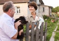 Friendly neighbors discuss their cats on the farm Royalty Free Stock Photo