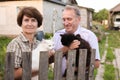 Friendly neighbors discuss their cats on the farm Royalty Free Stock Photo