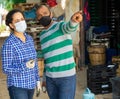 Friendly neighbors in protective masks discuss on farm in village Royalty Free Stock Photo