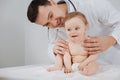 Friendly nice pediatrician playing with his little patient Royalty Free Stock Photo