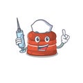 Friendly nurse of cherry macaron mascot design holding syringe Royalty Free Stock Photo