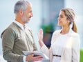 Friendly office conversations. two business colleagues having a discussion at the office. Royalty Free Stock Photo