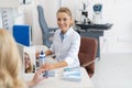 Friendly ophthalmologist prescribing contact lenses for patient Royalty Free Stock Photo